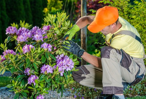 Gardener working safely with tools in a maintained outdoor space